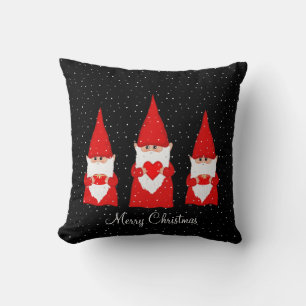 Trois lutins de Noël sur un coussin jeté noir