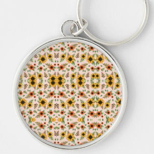 Un porte-clés rond avec un design en mosaïque flor