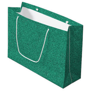 Un sac cadeau vert scintillant avec des poignées b