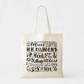 Un sac fourre-tout avec du texte noir dessus