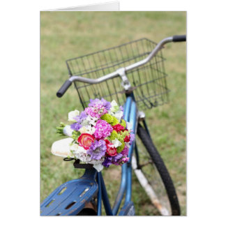 Vélo vintage avec carte à fleurs