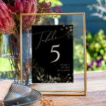 Verdure et or | Numéro de table noire<br><div class="desc">Entrez dans un monde enchanteur avec notre verdure fantaisiste et notre or | numéro de table noire, parfait pour votre réception de mariage botanique de printemps. Orné d'eucalyptus vert sauge et d'accents dorés, ce numéro de tableau exsude l'élégance et de fantaisie moderne. Imaginez vous promener dans un jardin d'été magique,...</div>