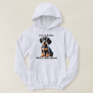 Veste À Capuche Jeune Dachshund assis et regardant avec innocence